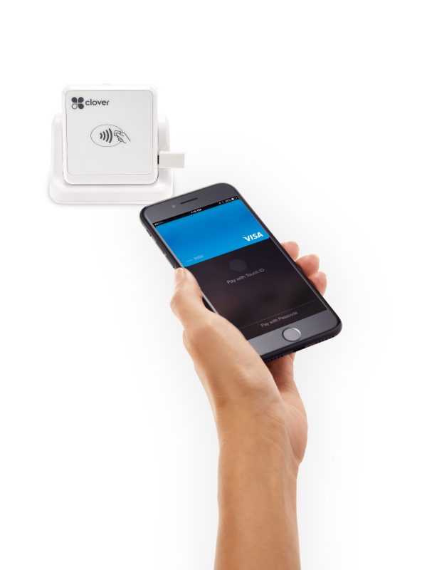 Image of a hand holding a smartphone, about to tap the Clover Go point-of-sale equipment from Monify.