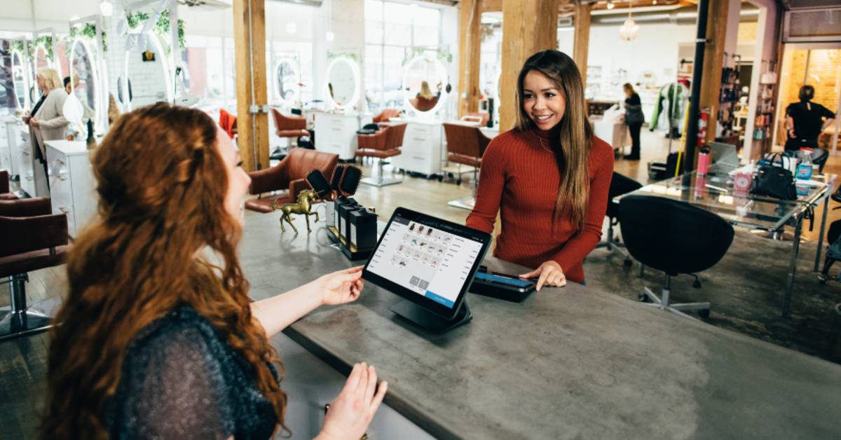 image of a woman paying using a POS system
