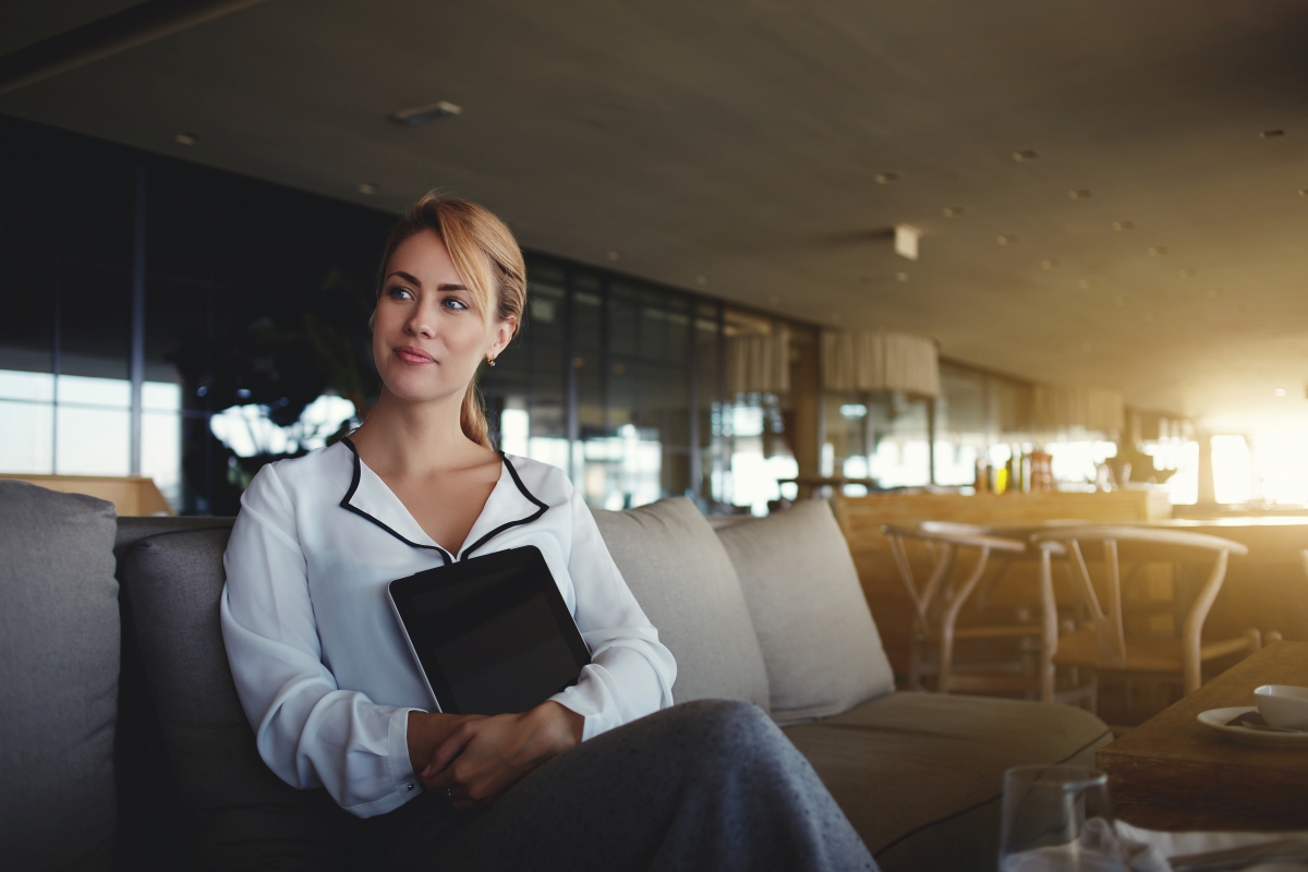 Woman luxury coffee shop owner with digital tablet